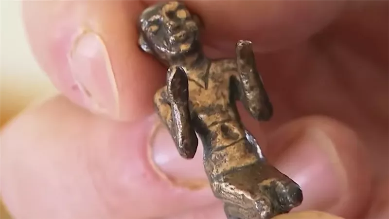 لحظة الكشف عن تمثال معدني من أسفل الرمال.. ما حكايته وإلى أي عصر يعود؟
